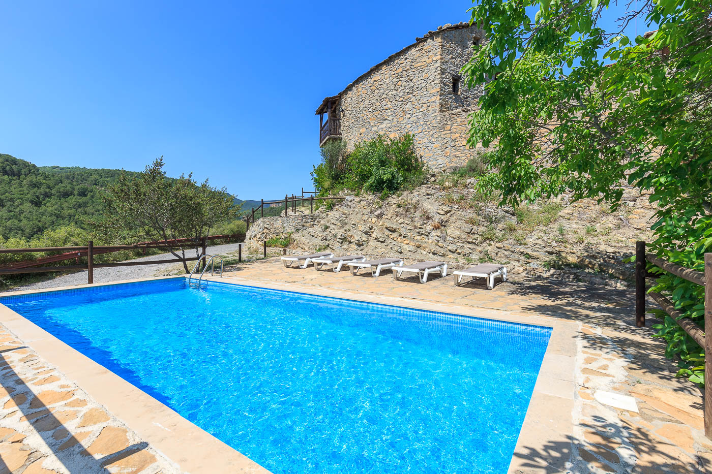 The pool is directly below the house
